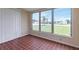 Enclosed room featuring tile flooring, large windows offering expansive views, and bright natural light at 211 Dalton Blvd, Port Charlotte, FL 33952