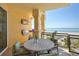 Outdoor patio with ocean views, built-in grill, and dining area perfect for entertaining at 2141 Gulf Of Mexico Dr Unit # 4, Longboat Key, FL 34228