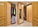 Spacious walk-in closet featuring custom wood cabinetry and ample storage for clothing and accessories at 2141 Gulf Of Mexico Dr Unit # 4, Longboat Key, FL 34228