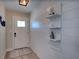 Hallway with white shiplap walls and floating shelves at 2428 Whippoorwill Cir, Sarasota, FL 34231