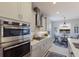 Well-lit kitchen featuring stainless steel appliances, a gas range, and stylish white cabinetry, and a breakfast nook at 352 Chantilly Trl, Bradenton, FL 34212