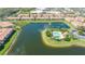 Aerial view shows the community pool, pond with fountain, and rows of townhome-style condos at 3769 Parkridge Cir # 4-103, Sarasota, FL 34243