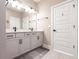 Well-lit bathroom with double vanity, quartz countertop, and modern fixtures at 3802 Savanna Palms Ct, Bradenton, FL 34211