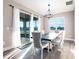 Dining area featuring elegant lighting, a large sliding door and peaceful outdoor views at 3802 Savanna Palms Ct, Bradenton, FL 34211