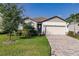 Charming one-story home with a well-manicured lawn, neutral color palette, and inviting curb appeal at 3802 Savanna Palms Ct, Bradenton, FL 34211