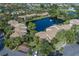 Stunning aerial view of the community with a beautiful pond featuring a fountain surrounded by lush landscaping and residences at 3810 75Th W St # 123, Bradenton, FL 34209