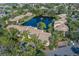Aerial view of community homes surrounding a serene lake with a central fountain feature at 3810 75Th W St # 123, Bradenton, FL 34209