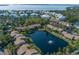 Gorgeous aerial view of the community featuring a pond with a fountain and access to the bay at 3810 75Th W St # 123, Bradenton, FL 34209