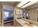 Bathroom with open view to bedroom from vanity mirror at 3810 75Th W St # 123, Bradenton, FL 34209