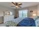 Bedroom featuring large window, ceiling fan and white dresser at 3810 75Th W St # 123, Bradenton, FL 34209