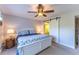 Cozy bedroom features a white bed frame, soft lighting, a ceiling fan, and a barn door to the bathroom at 3810 75Th W St # 123, Bradenton, FL 34209