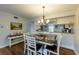 Bright dining room with wood-look floors and casual beachy decor flows into an adjacent kitchen at 3810 75Th W St # 123, Bradenton, FL 34209