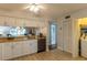 The kitchen has tile floors, white cabinets, stainless steel appliances, and an open bar concept at 3810 75Th W St # 123, Bradenton, FL 34209