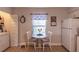 Cozy breakfast nook with a table and two chairs, conveniently located next to the laundry closet at 3810 75Th W St # 123, Bradenton, FL 34209