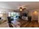 Bright living room featuring wood floors, ceiling fan, and a sliding glass door to a screened-in patio at 3810 75Th W St # 123, Bradenton, FL 34209