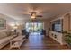 Open concept living area features wood-look floors and a large entertainment center at 3810 75Th W St # 123, Bradenton, FL 34209