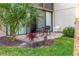 Private patio with outdoor seating, surrounded by tropical landscaping, perfect for relaxing or entertaining at 3810 75Th W St # 123, Bradenton, FL 34209