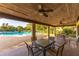 Covered patio area with ceiling fans and outdoor seating, overlooking the community pool at 3810 75Th W St # 123, Bradenton, FL 34209