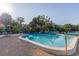 Community pool surrounded by lush landscaping and comfortable seating, perfect for relaxation and recreation at 3810 75Th W St # 123, Bradenton, FL 34209