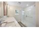 Bright bathroom with double vanity, modern fixtures, and glass-enclosed walk-in shower at 432 W Gate Dr, Venice, FL 34285