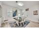 Bright dining room with a modern table, stylish decor, shiplap walls and lovely natural light at 432 W Gate Dr, Venice, FL 34285