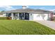 Charming single-story home featuring lush green lawn, inviting front porch and attached two-car garage at 432 W Gate Dr, Venice, FL 34285