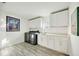 Well-organized laundry room featuring modern washer and dryer, ample counter space, and white cabinets at 432 W Gate Dr, Venice, FL 34285