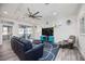 Cozy living room with a comfortable sofa, entertainment center, and bright, natural light at 432 W Gate Dr, Venice, FL 34285
