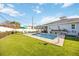 Inviting backyard featuring a sparkling pool, lush lawn, and charming outdoor decor at 432 W Gate Dr, Venice, FL 34285