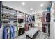 Spacious walk-in closet featuring custom shelving, hanging rods, and stylish bench seating at 432 W Gate Dr, Venice, FL 34285