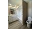 Bathroom featuring shower over tub, white vanity, and laminate flooring at 4509 30Th Street E Cir, Bradenton, FL 34203