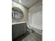 Bathroom featuring shower over tub, circular mirror, and laminate flooring at 4509 30Th Street E Cir, Bradenton, FL 34203