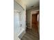 Bathroom featuring shower over tub, white vanity, and laminate flooring at 4509 30Th Street E Cir, Bradenton, FL 34203