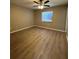 Bedroom featuring a window, a ceiling fan, and laminate flooring at 4509 30Th Street E Cir, Bradenton, FL 34203