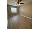 Bedroom with a ceiling fan, a window, and laminate flooring at 4509 30Th Street E Cir, Bradenton, FL 34203