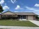 Charming single-story home featuring a well-maintained lawn, colorful flower beds, and an attached two-car garage at 4509 30Th Street E Cir, Bradenton, FL 34203