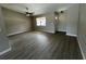 The living room has wood-look flooring, a ceiling fan, a large window, and a view of the front door at 4509 30Th Street E Cir, Bradenton, FL 34203