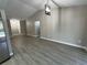 Spacious living room featuring vaulted ceilings, recessed lighting, and durable laminate flooring at 4509 30Th Street E Cir, Bradenton, FL 34203