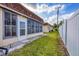 Charming backyard with privacy fence, lush grass, and sunroom exterior at 4608 Park Acres Dr, Bradenton, FL 34207