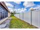 Fenced backyard with grass and partial view of the home's screened in porch at 4608 Park Acres Dr, Bradenton, FL 34207