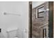 Modern bathroom featuring a glass-enclosed shower with attractive stone and grab bars at 4608 Park Acres Dr, Bradenton, FL 34207