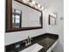 Stylish bathroom with granite countertop, attractive fixtures, and an oversized mirror at 4608 Park Acres Dr, Bradenton, FL 34207
