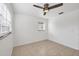 This bedroom features tile floors, a window, and a ceiling fan with overhead lighting at 4608 Park Acres Dr, Bradenton, FL 34207