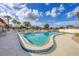 Kidney shaped community pool with ample lounge seating and manicured landscaping at 4608 Park Acres Dr, Bradenton, FL 34207