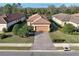 An aerial view showcases the property's meticulously maintained lawn, landscaping, and paved driveway at 5020 Savona Run, Bradenton, FL 34211