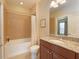 Well-lit bathroom features a bathtub, a single sink, and tiled walls at 5020 Savona Run, Bradenton, FL 34211