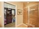 Bathroom view featuring a glass shower stall and a walk-in closet with custom organizers at 5020 Savona Run, Bradenton, FL 34211