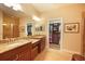 Bathroom has double sinks with granite counters, a walk-in shower, and easy access to the closet at 5020 Savona Run, Bradenton, FL 34211
