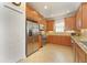 Kitchen boasts stainless steel appliances, granite counters, tile backsplash, and light wood cabinets at 5020 Savona Run, Bradenton, FL 34211