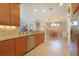 Open kitchen features granite countertops, stainless appliances, tile backsplash, and tile flooring at 5020 Savona Run, Bradenton, FL 34211